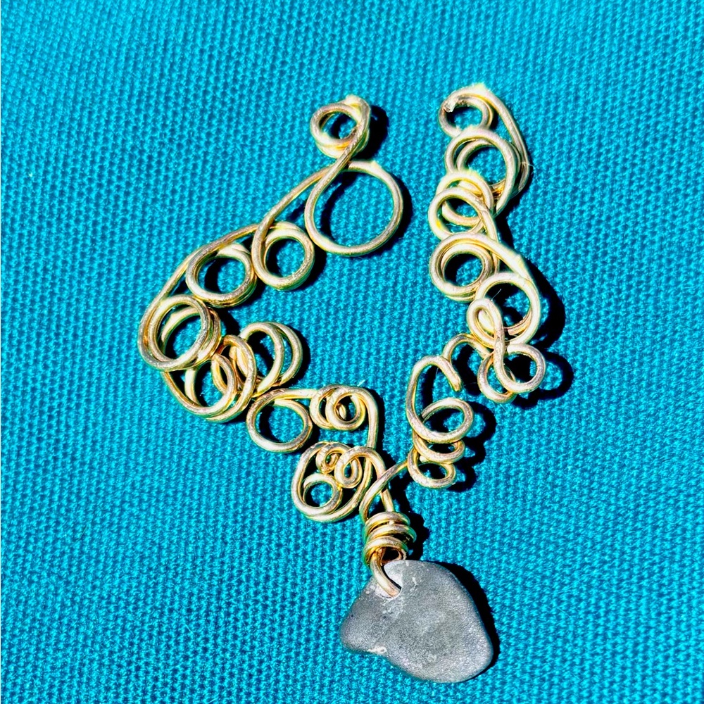 Hand wire wrapped Finger Lakes “lucky” stone pendant.